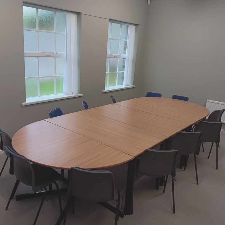 12 chairs around a large meeting room table